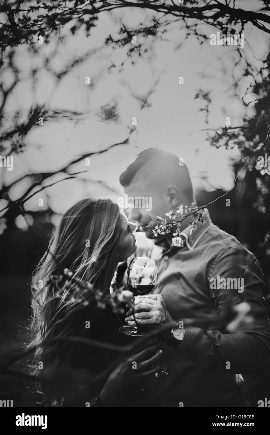 young couple embracing  in nature under the tree in spring Stock Photo