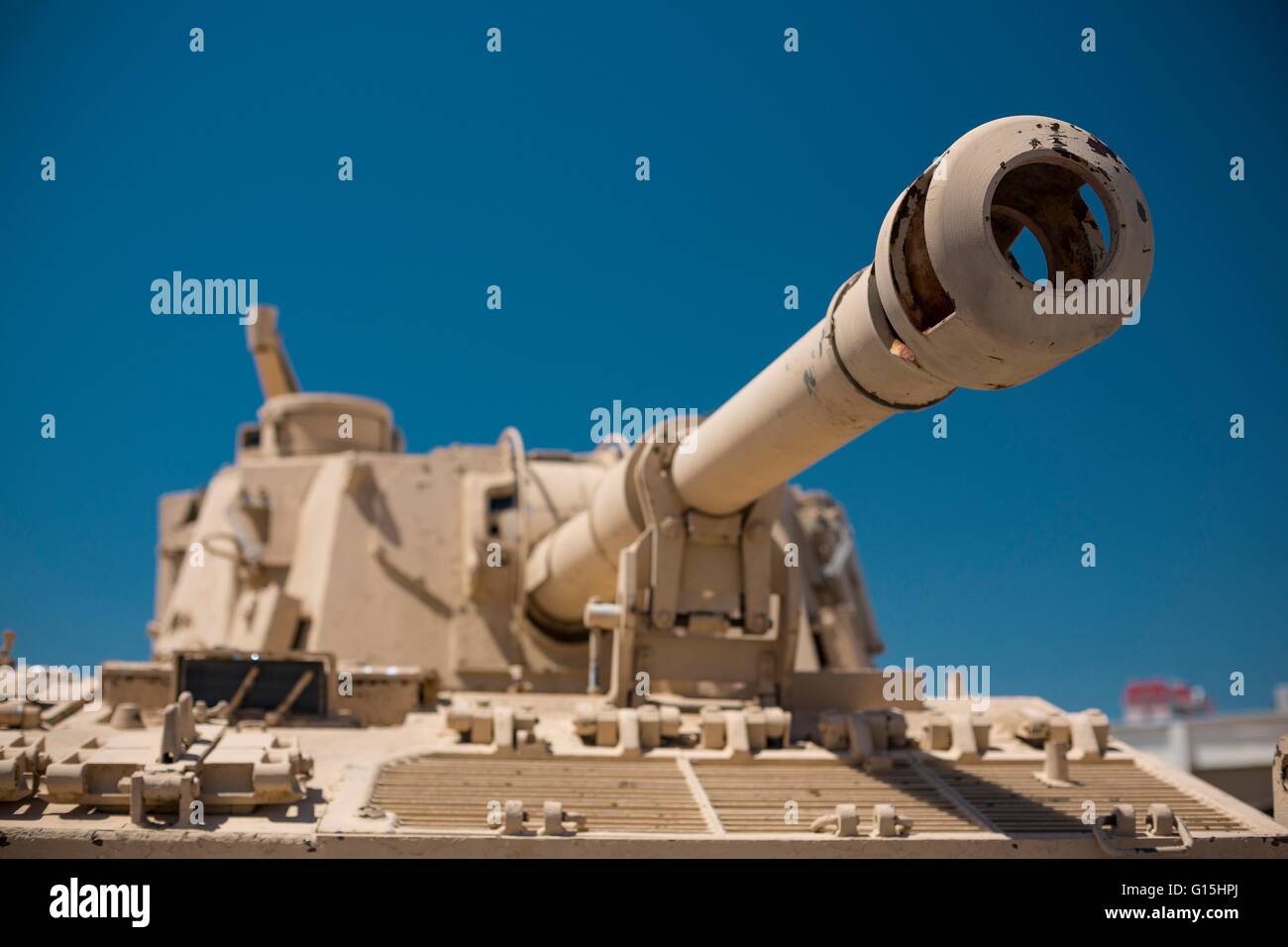 Heavy military desert camouflage tank turret gun aiming and ready to fire Stock Photo