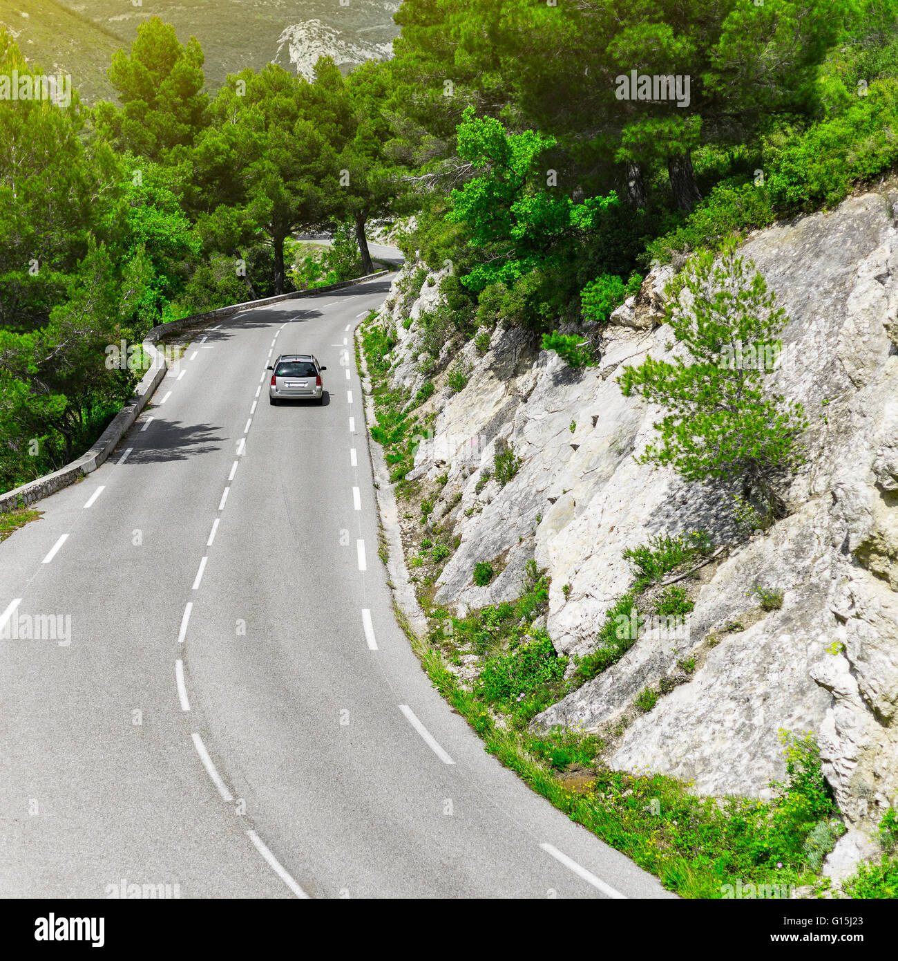 hatchback family station wagon car driving on a mountain road in a national park Stock Photo