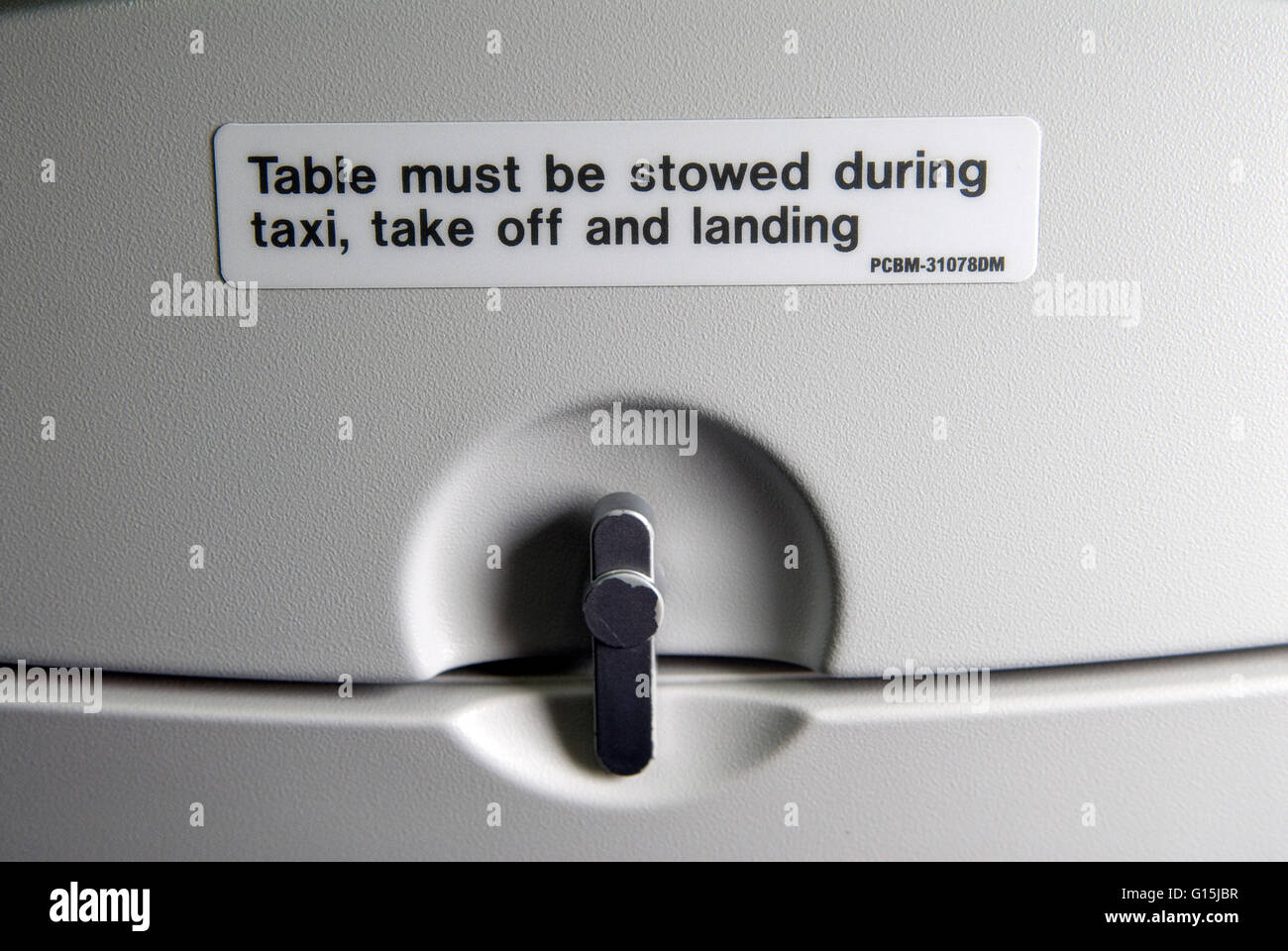 Tables must be stowed away during taxi take off and landing. Close up sign British Airways on the back of a passenger seat, drop down table detail in up position. 2016, 2010s, HOMER SYKES Stock Photo