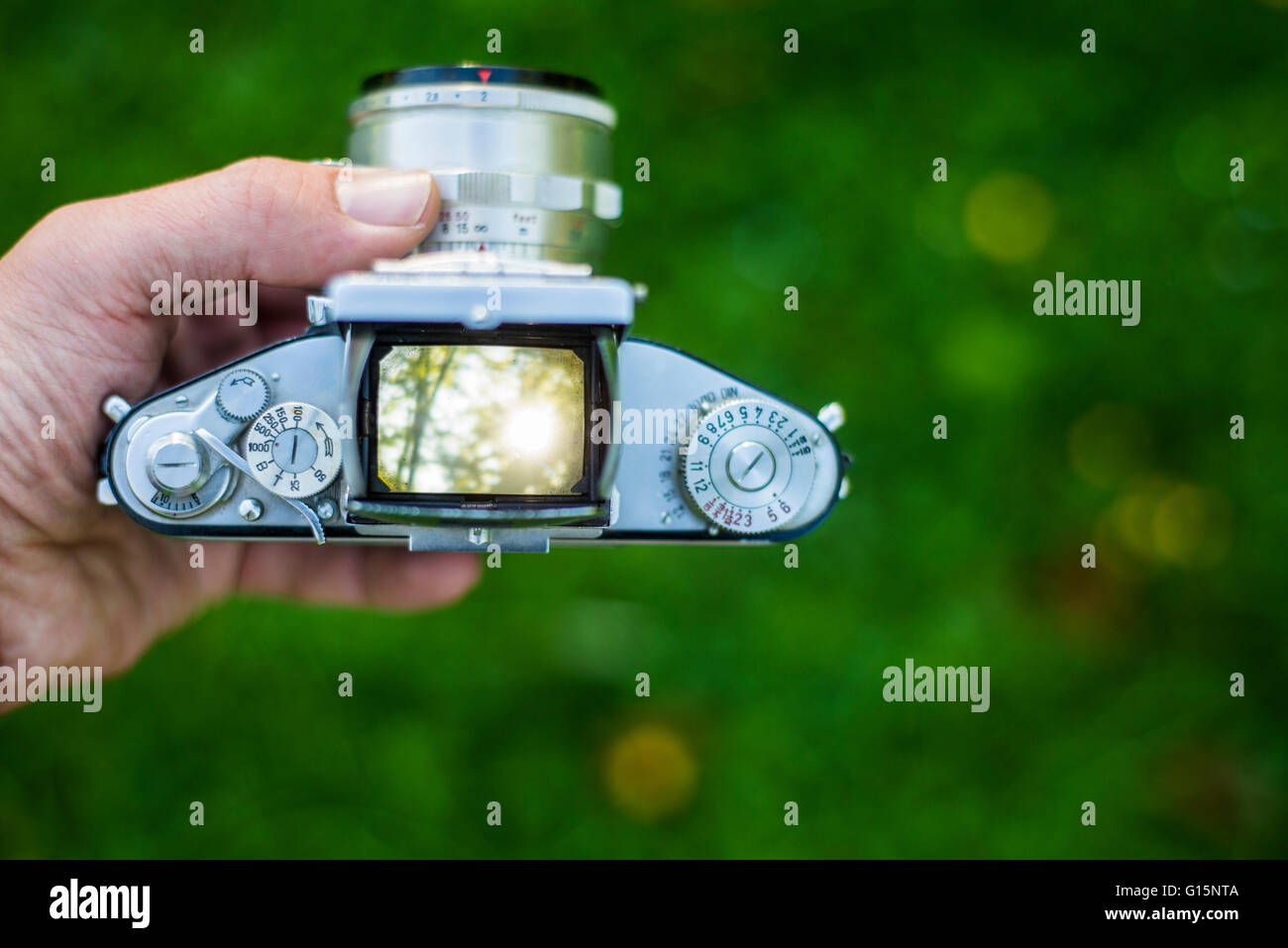 Shooting nature with old vintage 35mm film SLR camera. View through the viewfinder Stock Photo