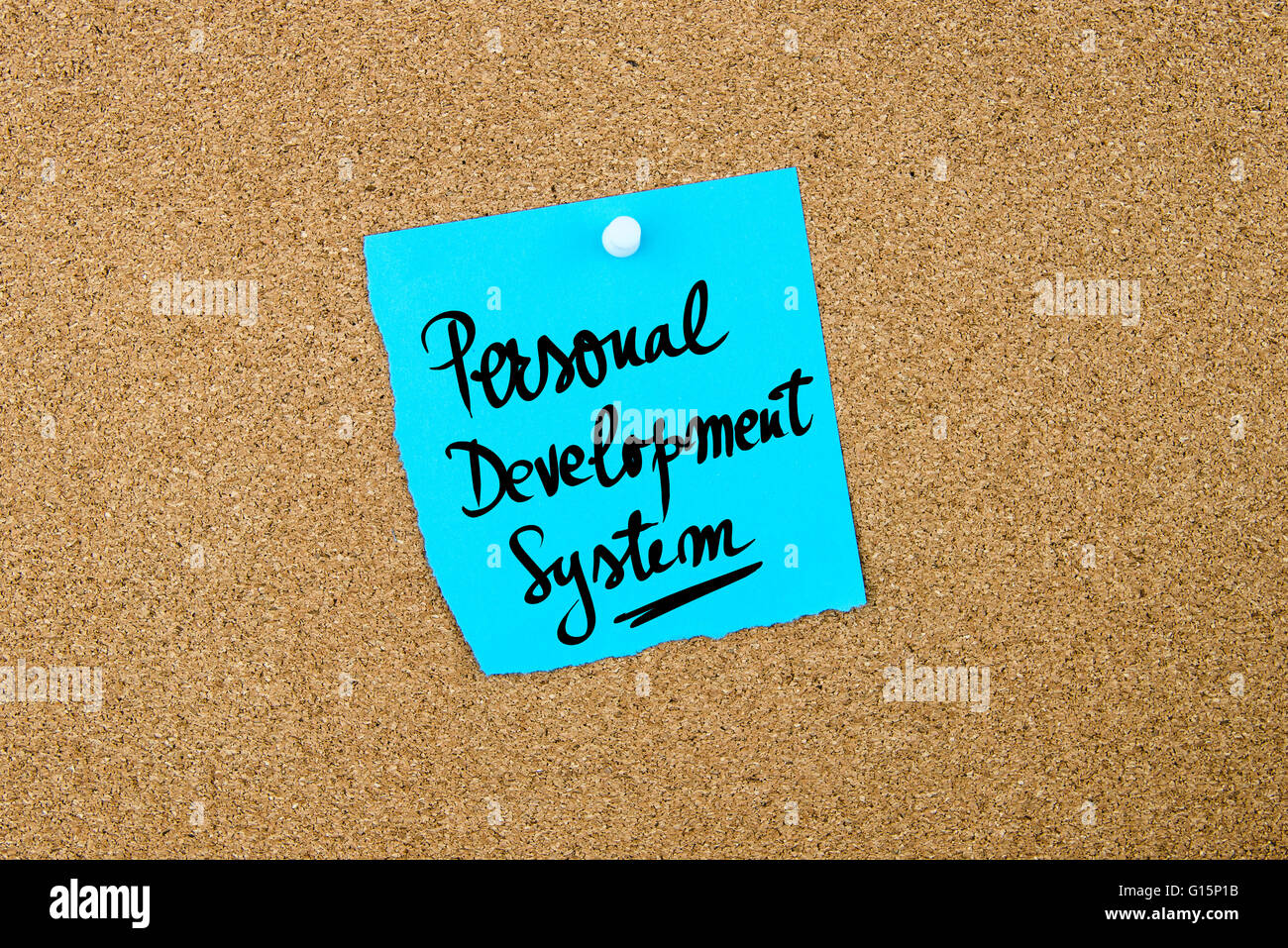 Personal Development System written on blue paper note pinned on cork board with white thumbtacks, copy space available Stock Photo