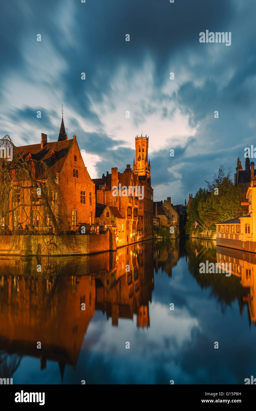 Rozenhoedkaai with Belfry along the Dijver canal after sunset in Bruges, Belgium Stock Photo