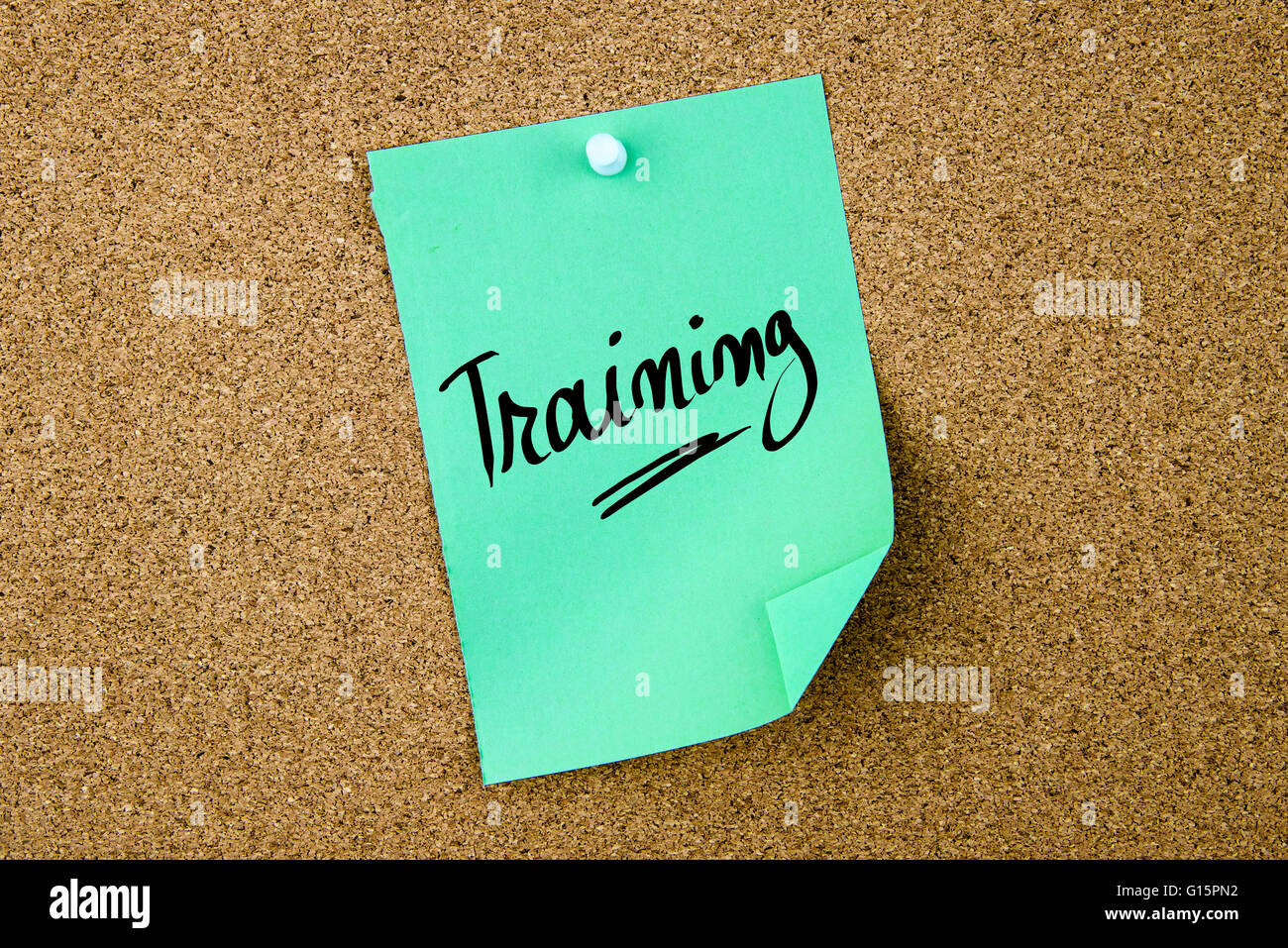 Training Note Board Training written on green paper note pinned on cork board with white ...