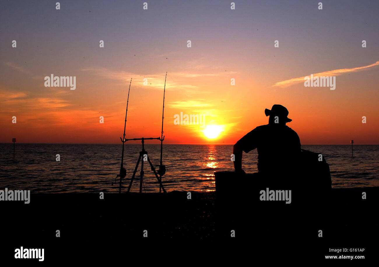 Weather . . Heacham, West Norfolk, UK . . 08.05.2016 An fisherman watches his rods just before the sunset at Heacham, West Norfolk, after a very warm day. © Paul Marriott Photography Stock Photo