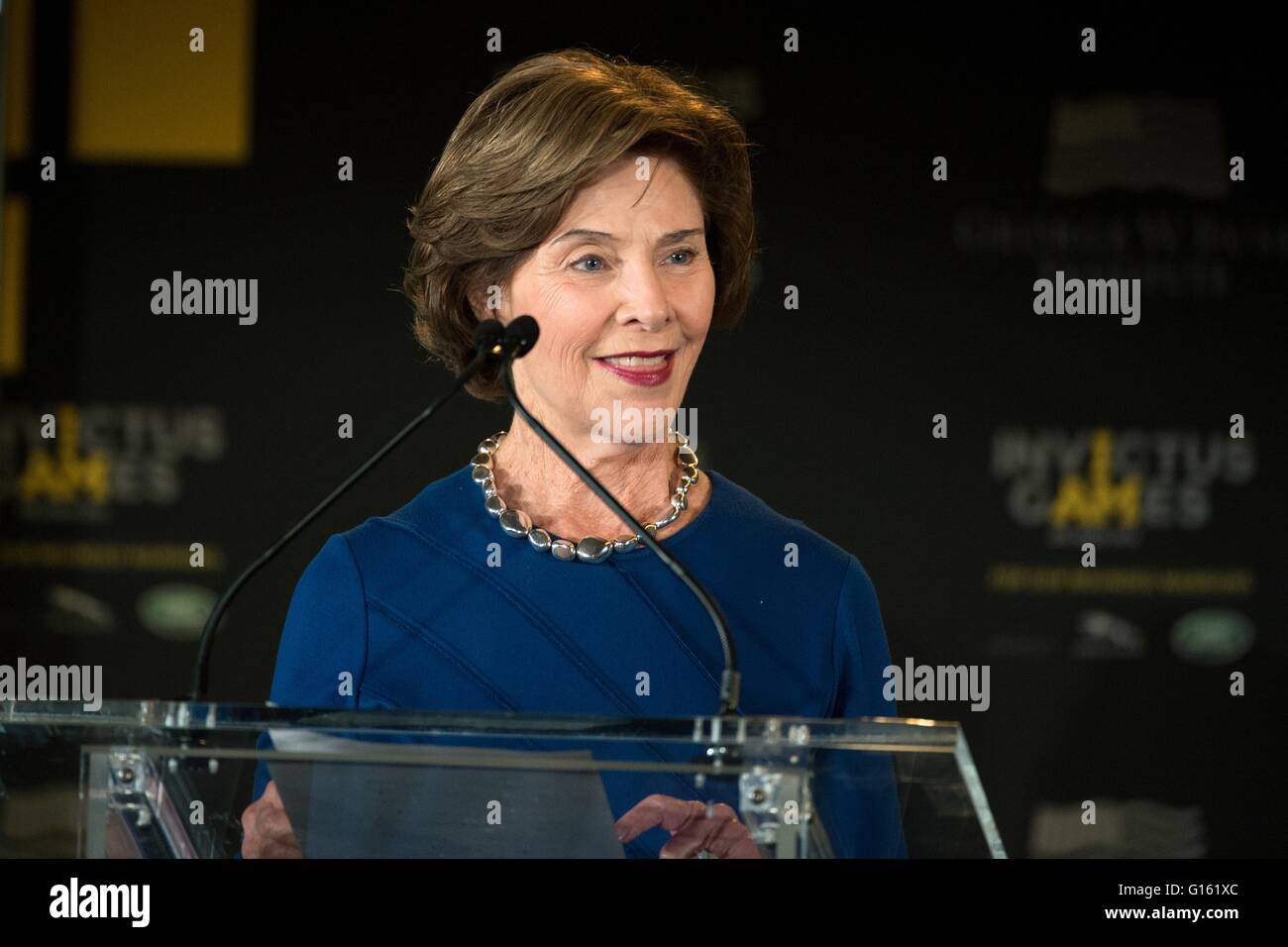 Former First Lady Laura Bush introduces Prince Harry and her husband former President George W Bush during the  2016 Invictus Games Symposium on Invisible Wounds May 8, 2016 in Orlando, Florida. The symposium hosted by Prince Harry and former President George W. Bush sought to remove the stigma suffered by victims of post traumatic stress and other injuries that are not regularly visible. Stock Photo