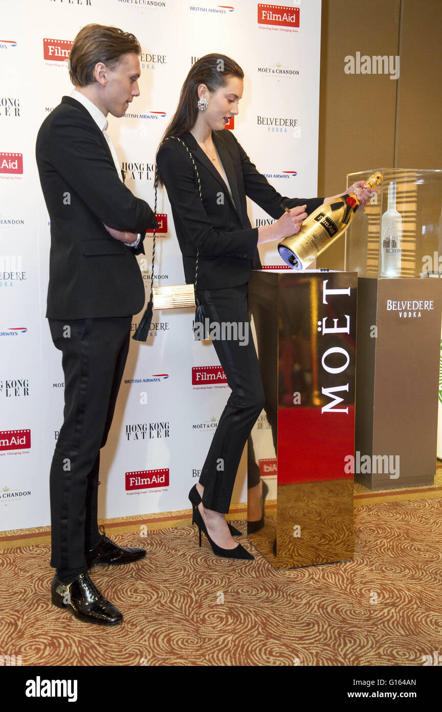 Jamie Campbell-Bower(L) with girlfriend Mathilda Lowther signing the bottle of champagne to auctioned during the gala for FilmAid. FilmAid Asia hosts their 4th Power of Film gala to raise funds for FilmAid Asia's programmes and honour humanitarian filmmaker Jessey Tsang as well as guest of honour, Rebel Wilson, Hong Kong on May 07, 2016 | Verwendung weltweit Stock Photo