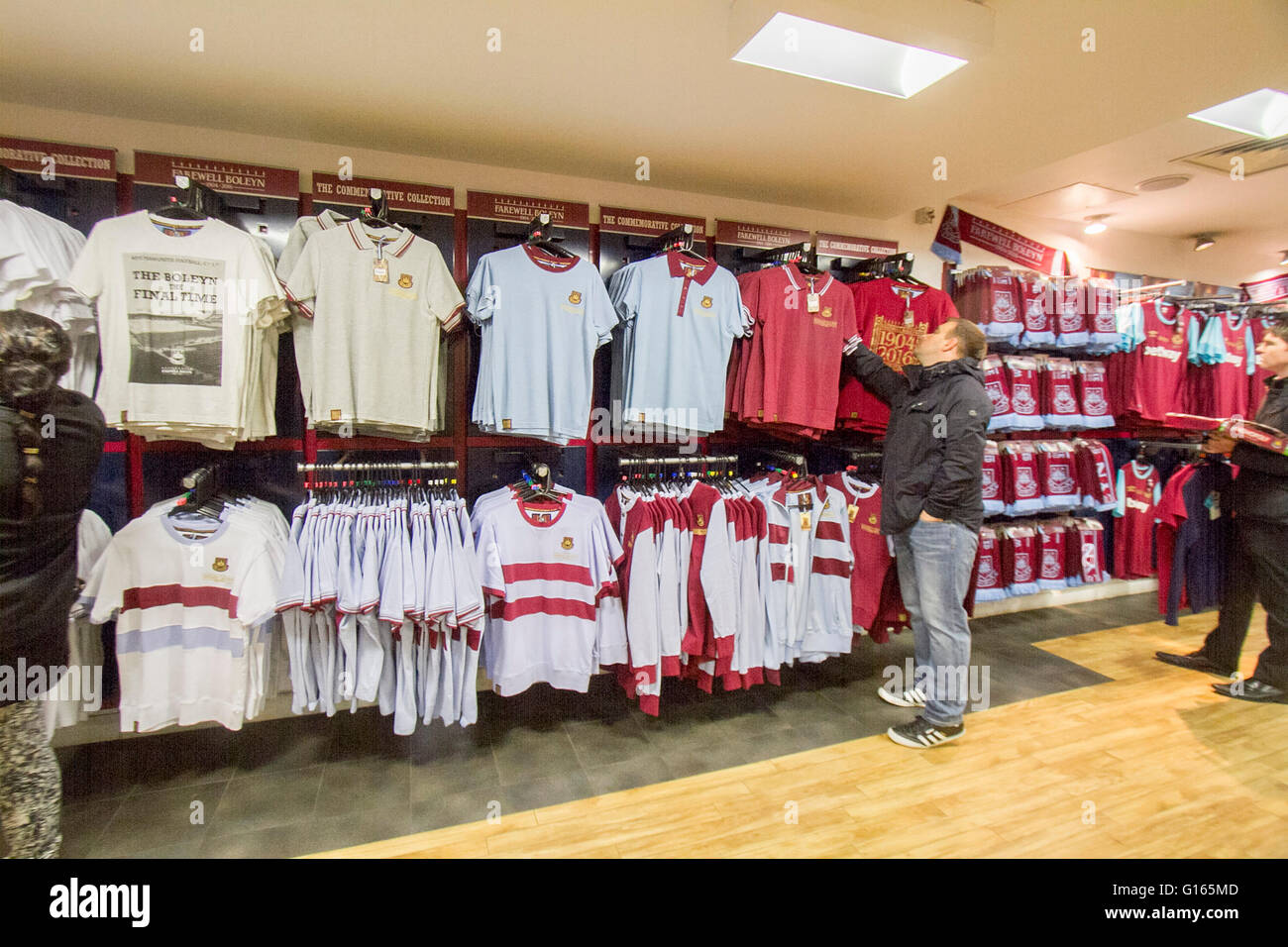 Upton Park London, UK. 10th May. A fan looking at memorabilia shirts inside  the club store as West Ham United Football club plays its final against  Manchester United at the Boleyn ground