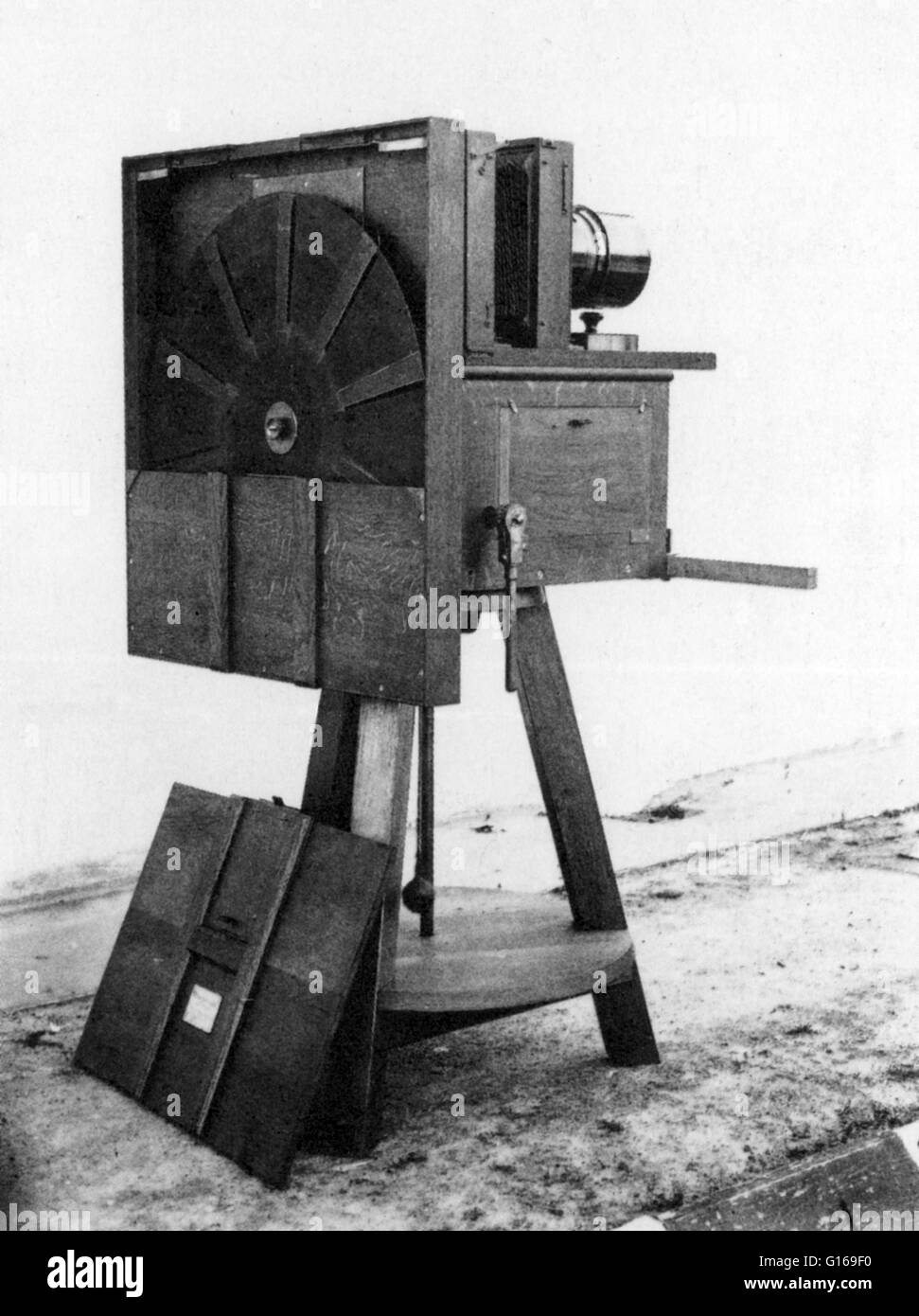 Marey's fixed-plate chronophotography machine, with ten slit-disk that acts as a shutter, on the ground is the sensitized-plate holder, 1883 model. The fixed plate camera was equipped with a timed shutter that was able to combine on a single plate several Stock Photo