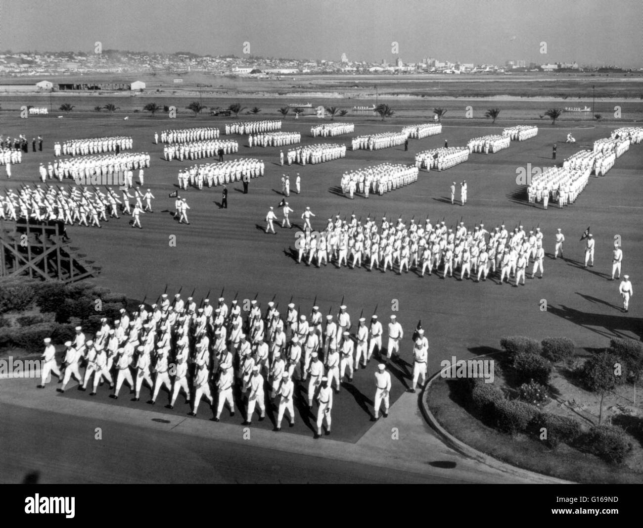 United States Naval Training Center, San Diego, California, late 1940's. A military parade is a formation of soldiers whose movement is restricted by close-order maneuvering known as drilling, formation, marching, or military review .The United States Navy (USN) is the naval warfare service branch of the United States Armed Forces and one of the seven uniformed services of the United States. Naval Training Center San Diego (NTC San Diego) (1923-1997) is a former United States Navy base located at the north end of San Diego Bay. The Naval Training Center site is listed on the National Register  Stock Photo