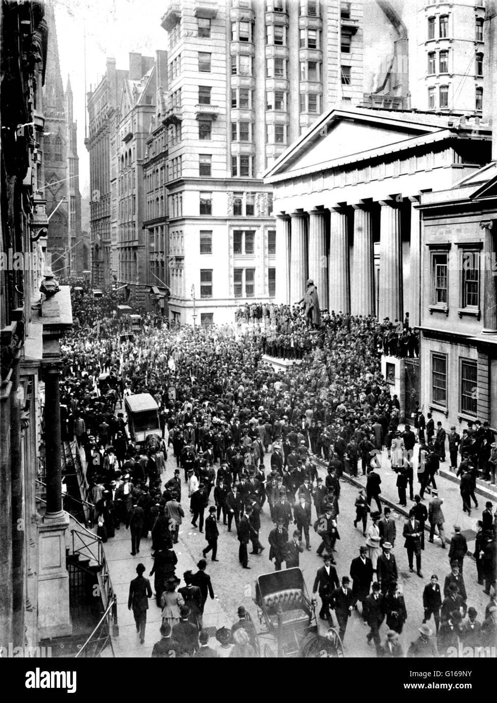 The Panic of 1907 was a financial crisis that occurred when the New York Stock Exchange fell almost 50% from its peak the previous year. It occurred during a time of economic recession, and there were numerous runs on banks and trust companies. The panic was triggered by the failed attempt in October 1907 to corner the market on stock of the United Copper Company. When this bid failed, banks that had lent money to the cornering scheme suffered runs that later spread to affiliated banks and trusts. On October 22, the Knickerbocker faced a classic bank run. From the bank's opening, the crowd gre Stock Photo