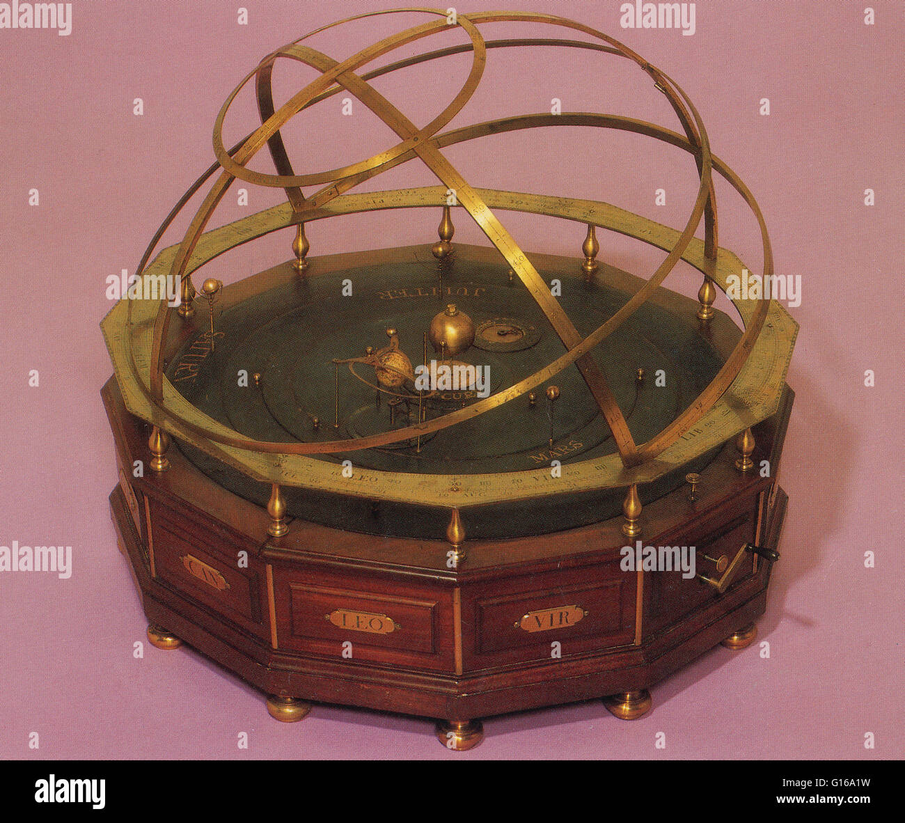An orrery is a mechanical device that illustrates the relative positions and motions of the planets and moons in the Solar System in a heliocentric model. Though the Greeks had working planetaria, the first orrery that was a planetarium of the modern era Stock Photo