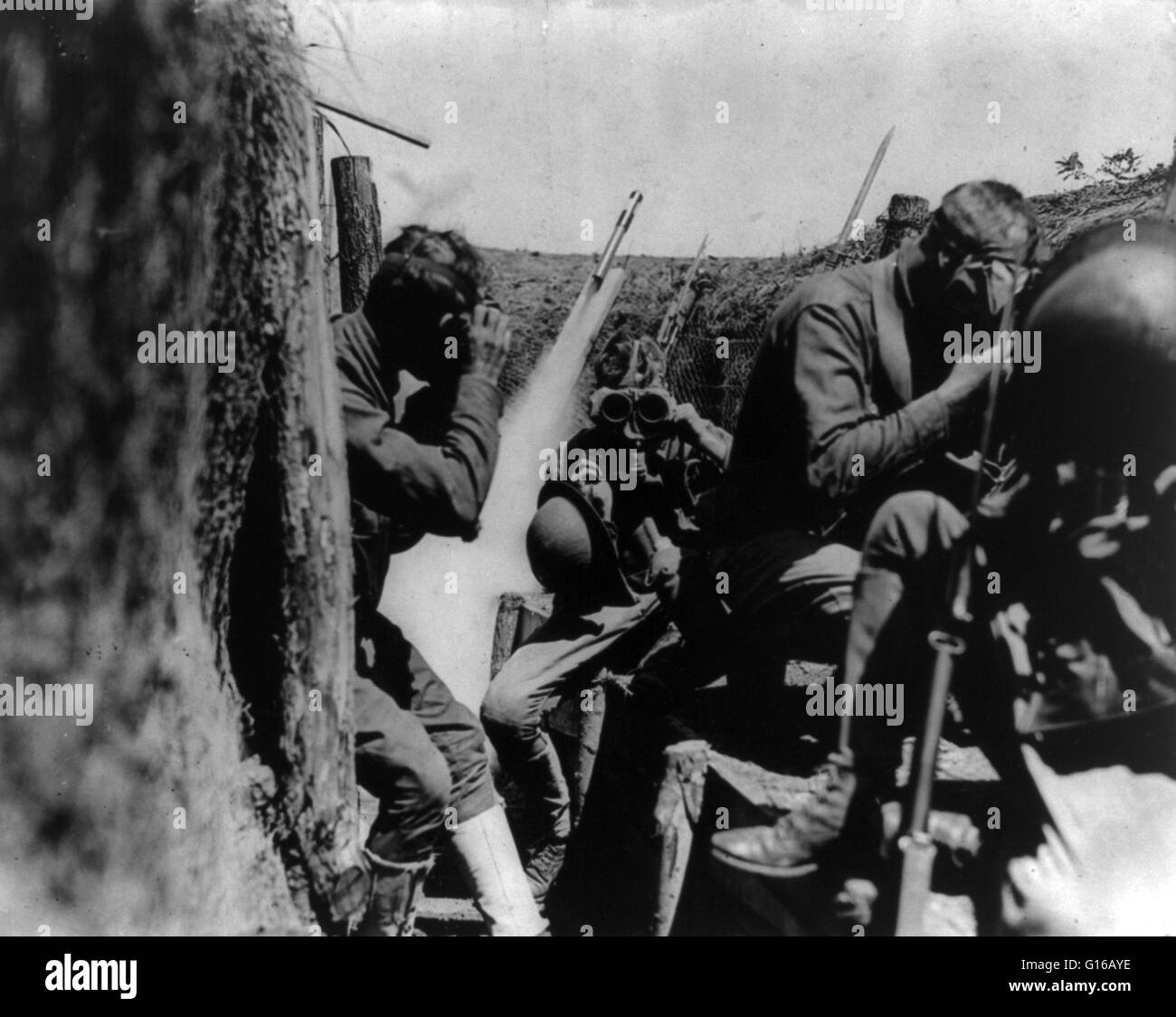 American soldiers in trench putting on gas masks, World War I. The first use of poison gas on the Western Front was on April 22, 1915, by the Germans at Ypres, against Canadian and French colonial troops. The British Royal Society of Chemistry claims that Stock Photo
