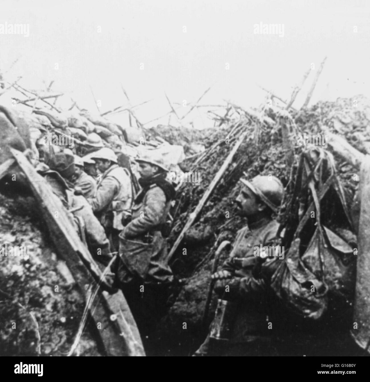 A World War I French departure trench just before zero hour, circa 1914-18. No location given on caption card. Trench warfare is a form of land warfare using occupied fighting lines consisting largely of trenches, in which troops are significantly protect Stock Photo