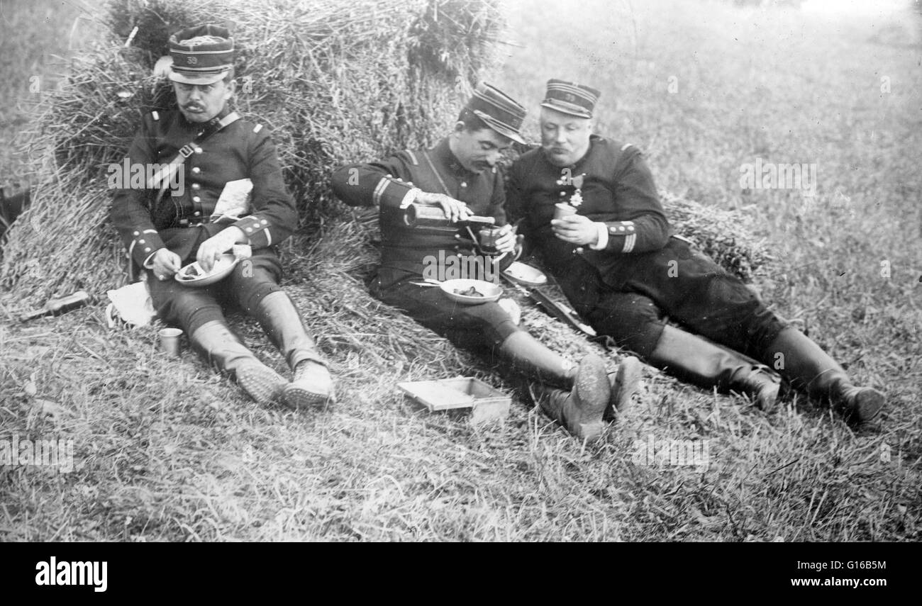 French officers eating and drinking wine in a field during World War I