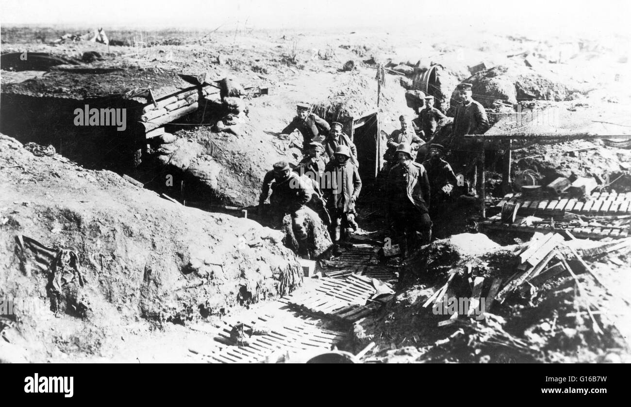 German soldiers in a trench. Trench warfare is a form of land warfare using occupied fighting lines consisting largely of trenches, in which troops are significantly protected from the enemy's small arms fire and are substantially sheltered from artillery Stock Photo