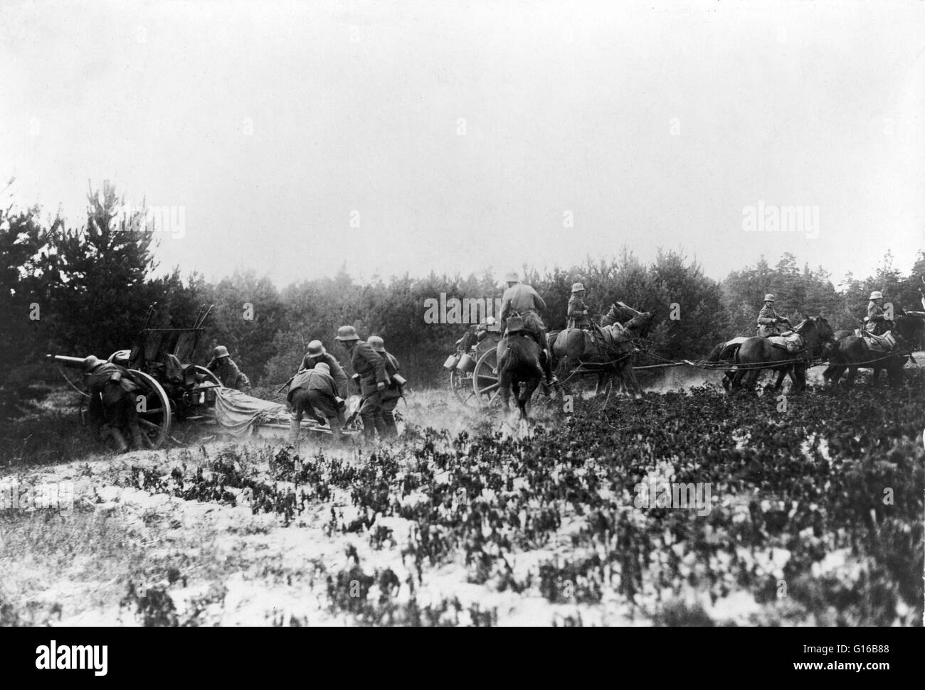 German soldiers firing(unidentified) artillery gun while other soldiers on horseback move a wagon. Horse artillery was a type of light, fast-moving and fast-firing artillery which provided highly mobile fire support to European and American armies (especi Stock Photo
