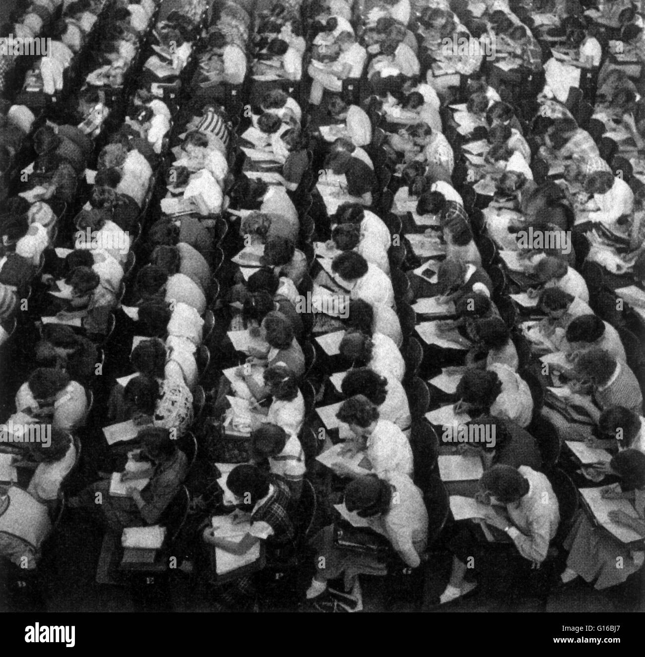 Students take the Scholastic Aptitude Test (SAT) in Lincoln, Nebraska, 1953. The SAT is a standardized test for most college admissions in the United States. The SAT is owned, published, and developed by the College Board, a nonprofit organization in the Stock Photo