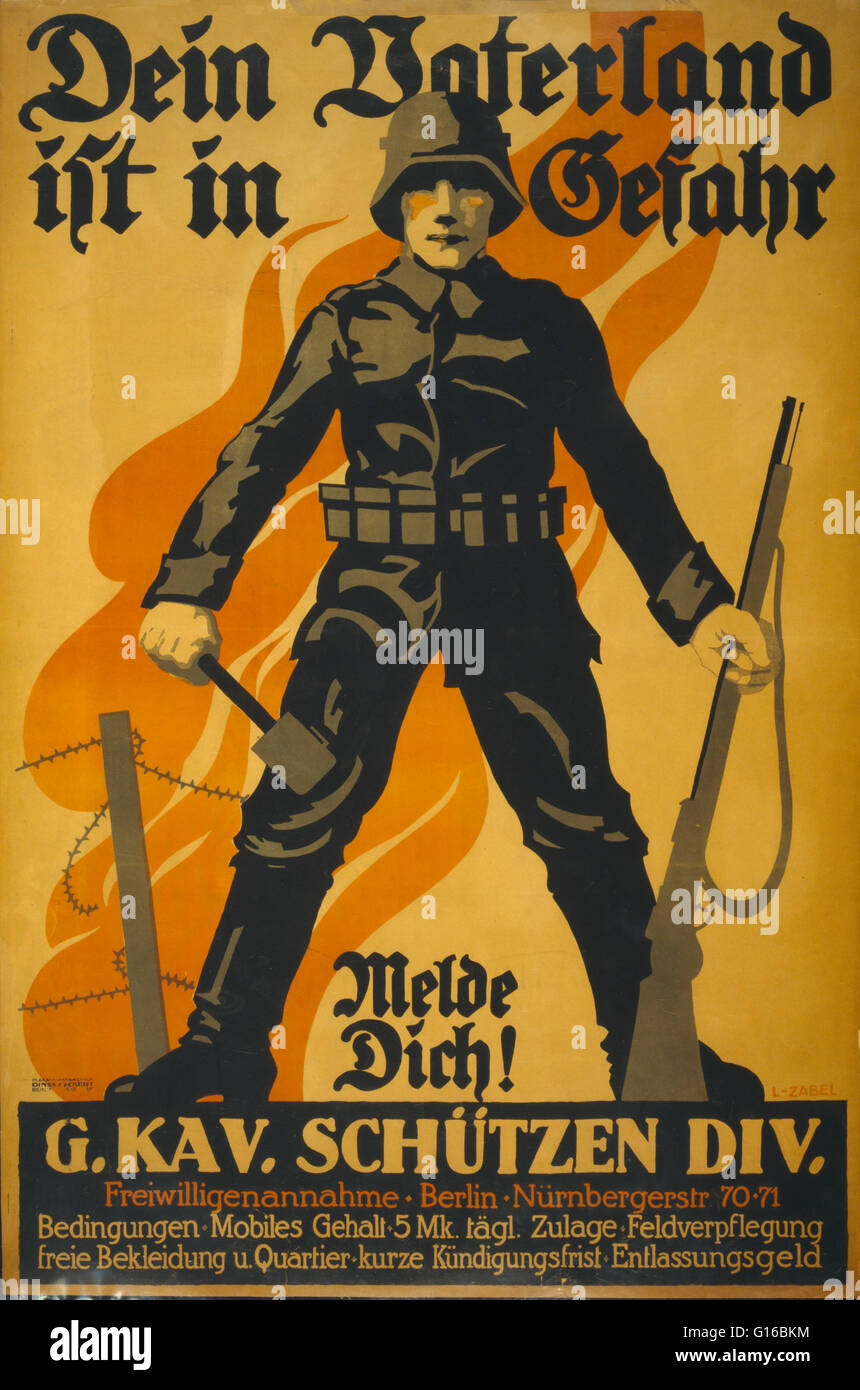 Entitled: 'Dein Vaterland ist in Gefahr, melde dich!.' Poster shows a German soldier, holding a grenade in one hand and a rifle in the other; in background a barbed wire fence and flames. Text encourages enlistment in the G. Kav. Schützen Div. with the sl Stock Photo