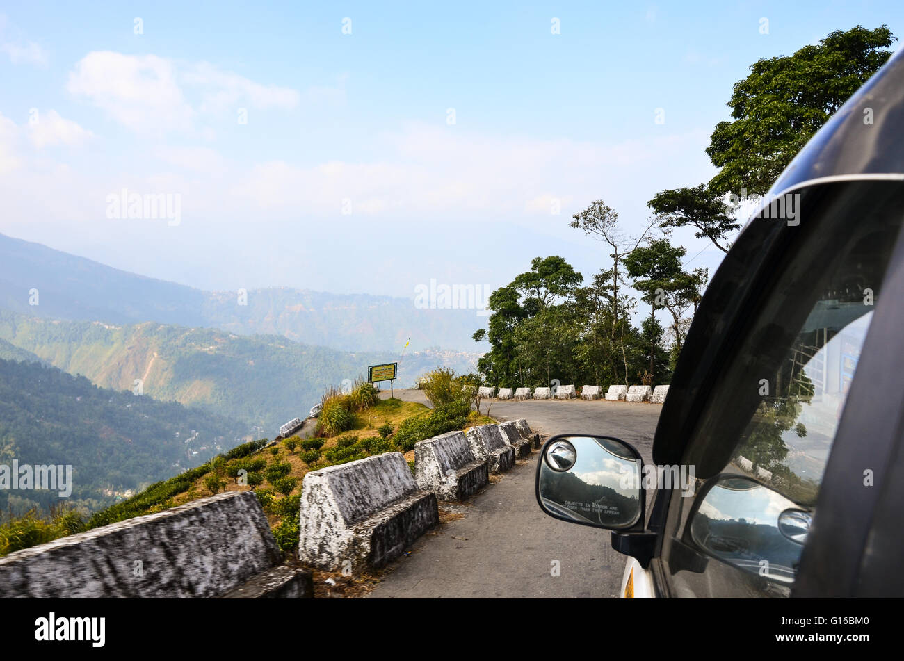 View from car passenger seat - Beautiful scenery along the curvy Bloomfield Road leading to Rock Garden, Darjeeling Stock Photo