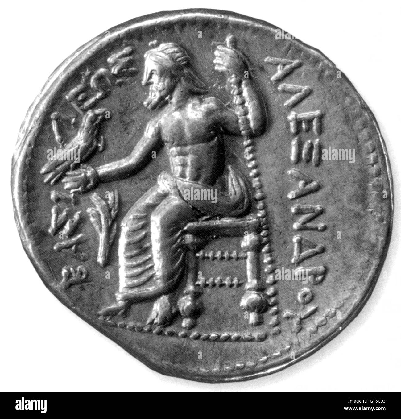 Reverse of a silver tetradrachm minted in Amphipolis during the reign of Alexander the Great. Zeus seating left on a throne, holding an eagle and a scepter. The tetradrachm was an Ancient Greek silver coin equivalent to four drachmae and it was in wide ci Stock Photo