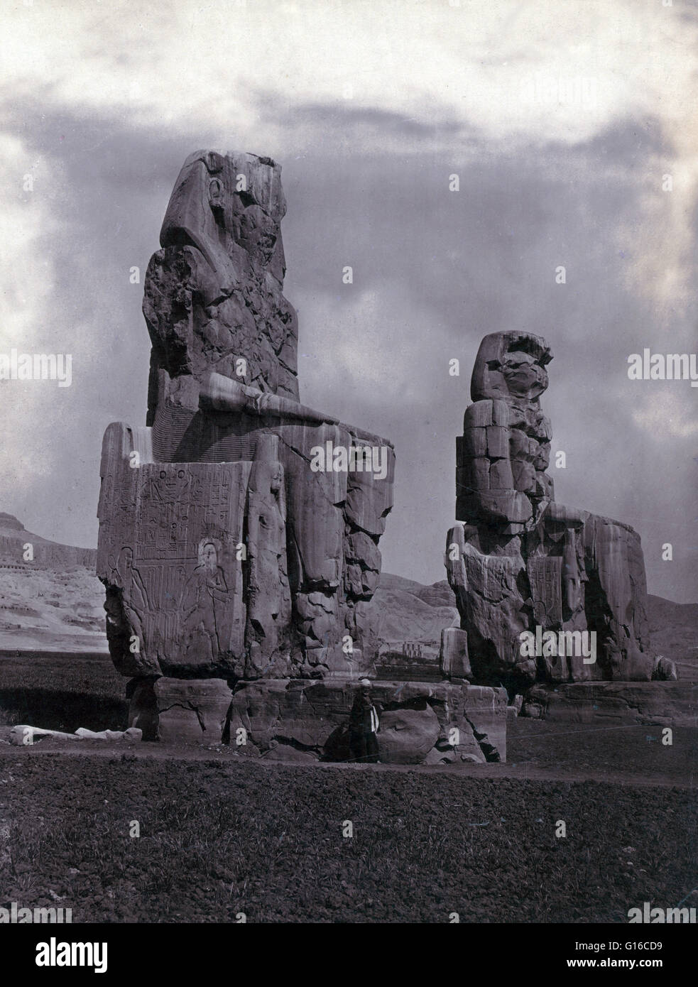 Twin reconstructed statues of Memnon seated on throne, Egypt, photographed by Francis Frith, circa 1856-1860. The Colossi of Memnon are two massive stone statues of Pharaoh Amenhotep III. His reign was a period of unprecedented prosperity and artistic spl Stock Photo