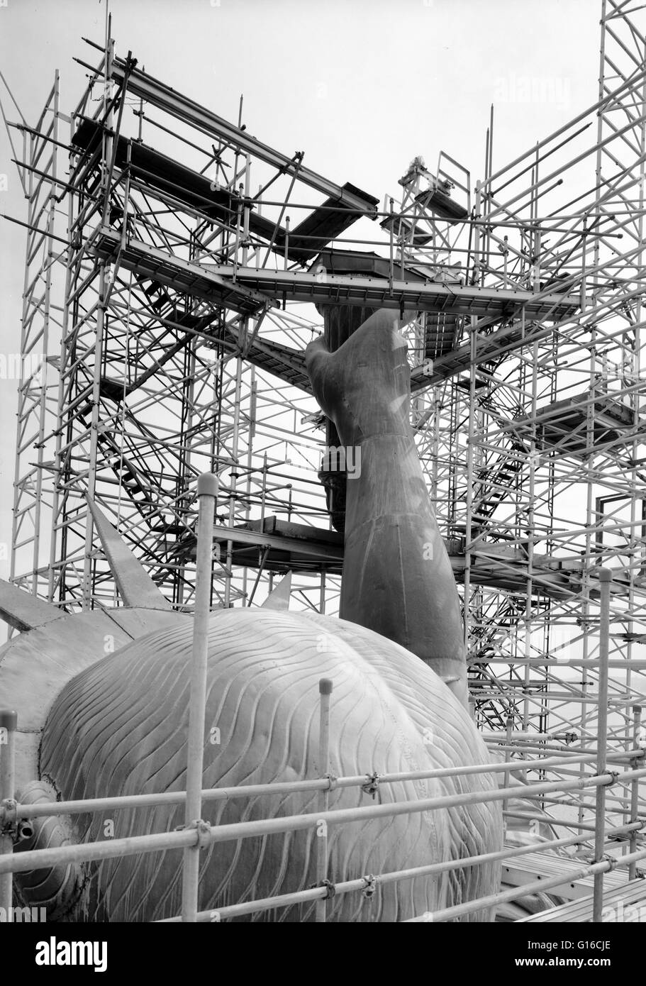 Entitled: 'View looking southeast showing back of head and torch arm after flame has been removed, March 1985.' The Statue of Liberty is a colossal neoclassical sculpture on Liberty Island in New York Harbor, designed by Frédéric Bartholdi and dedicated o Stock Photo