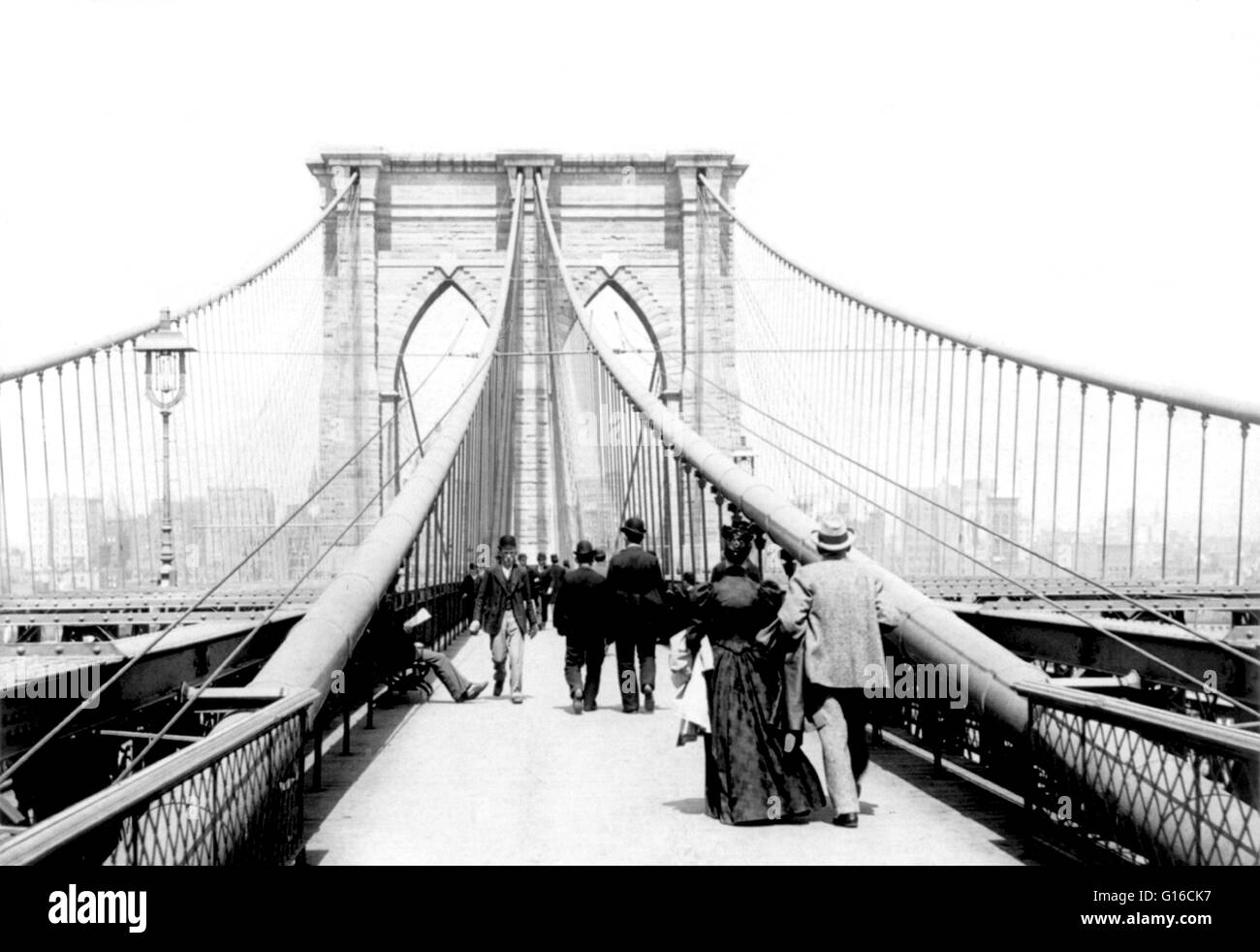 View looking across the Brooklyn Bridge, N.Y.C. with people walking in both directions, 1894. The Brooklyn Bridge is one of the oldest suspension bridges in the United States. Completed in 1883, it connects the boroughs of Manhattan and Brooklyn by spanni Stock Photo