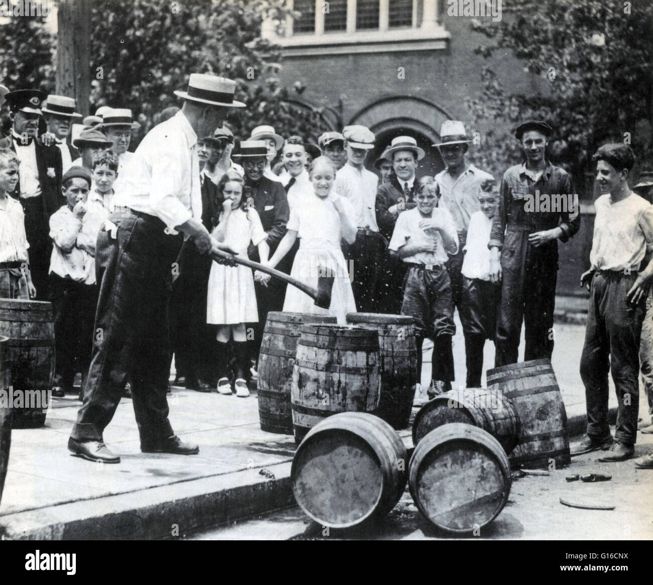 A Revenuer preparing to smash beer barrel with axe during Prohibition