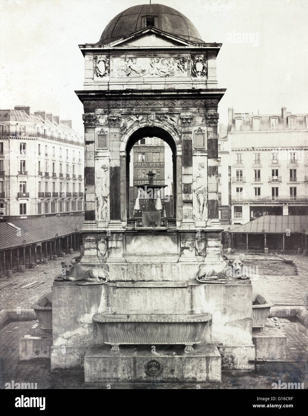 The Fontaine des Innocents as installed at the Marché des Innocents in Paris, just prior to one of its several relocations and reconstructions. Photographed by Charles Marville, 1858. Originally called the Fountain of the Nymphs, it was constructed betwee Stock Photo
