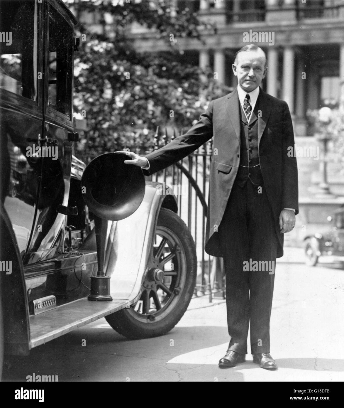 President Coolidge with his right hand on piece of radio equipment used on automobiles during the campaign, 1924. John Calvin Coolidge, Jr. (July 4, 1872 - January 5, 1933) was the 30th President of the United States (1923-1929). A Republican lawyer from Stock Photo