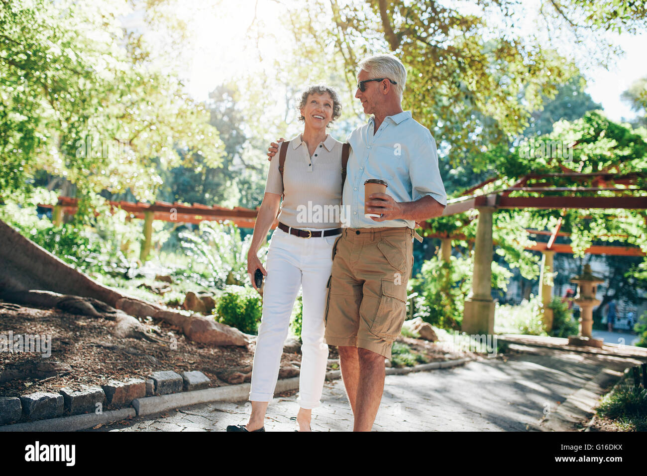 Full length portrait of an loving senior couple enjoying a walk in the park together. Tourist walking in a park. Stock Photo