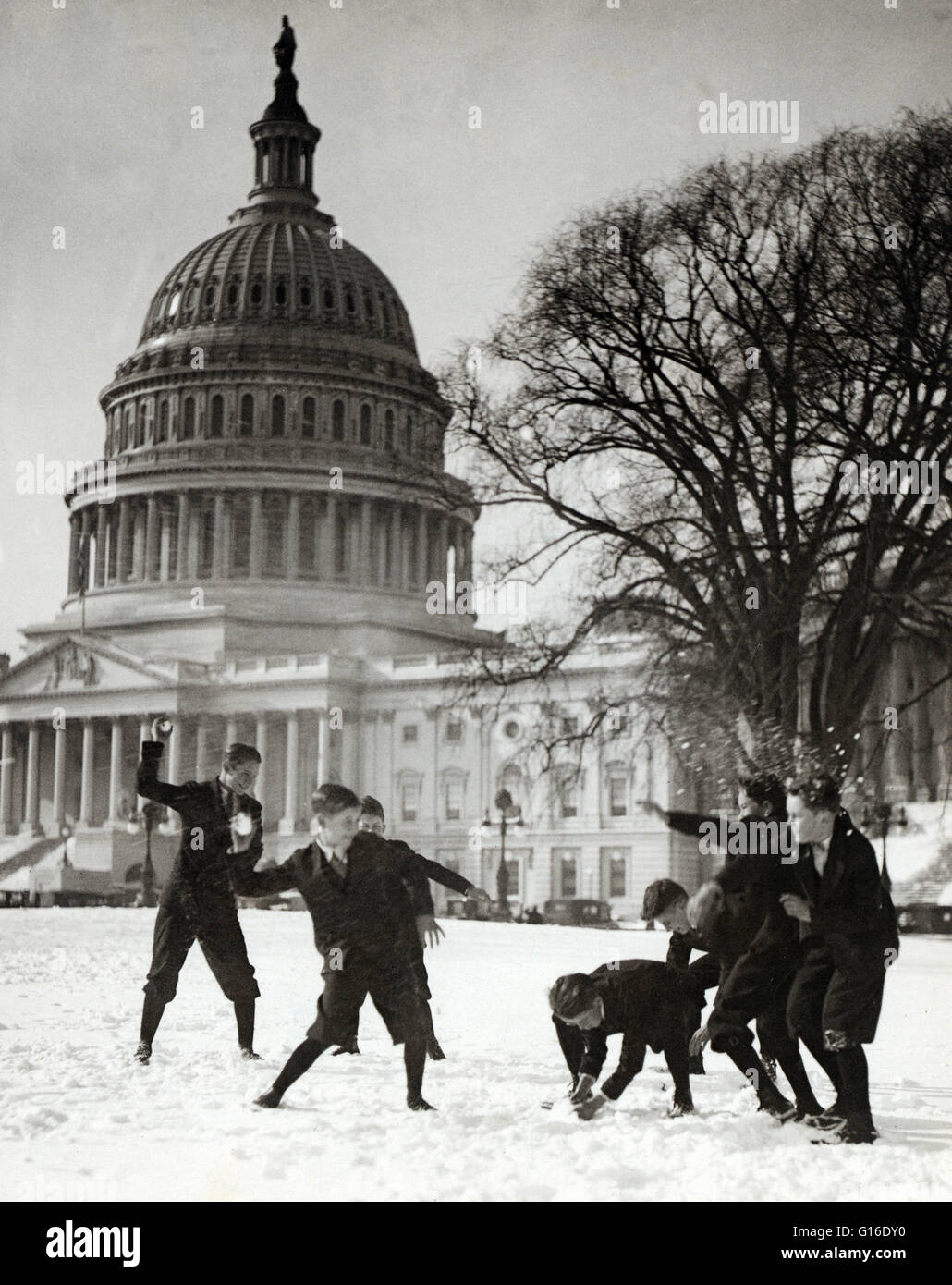 Entitled: 'Senate page boys stage their first snow battle on the Capitol plaza' shows seven boys in snowball battle in front of U.S. Capitol. A United States Senate Page is a non-partisan federal employee serving the United States Senate in Washington, DC Stock Photo