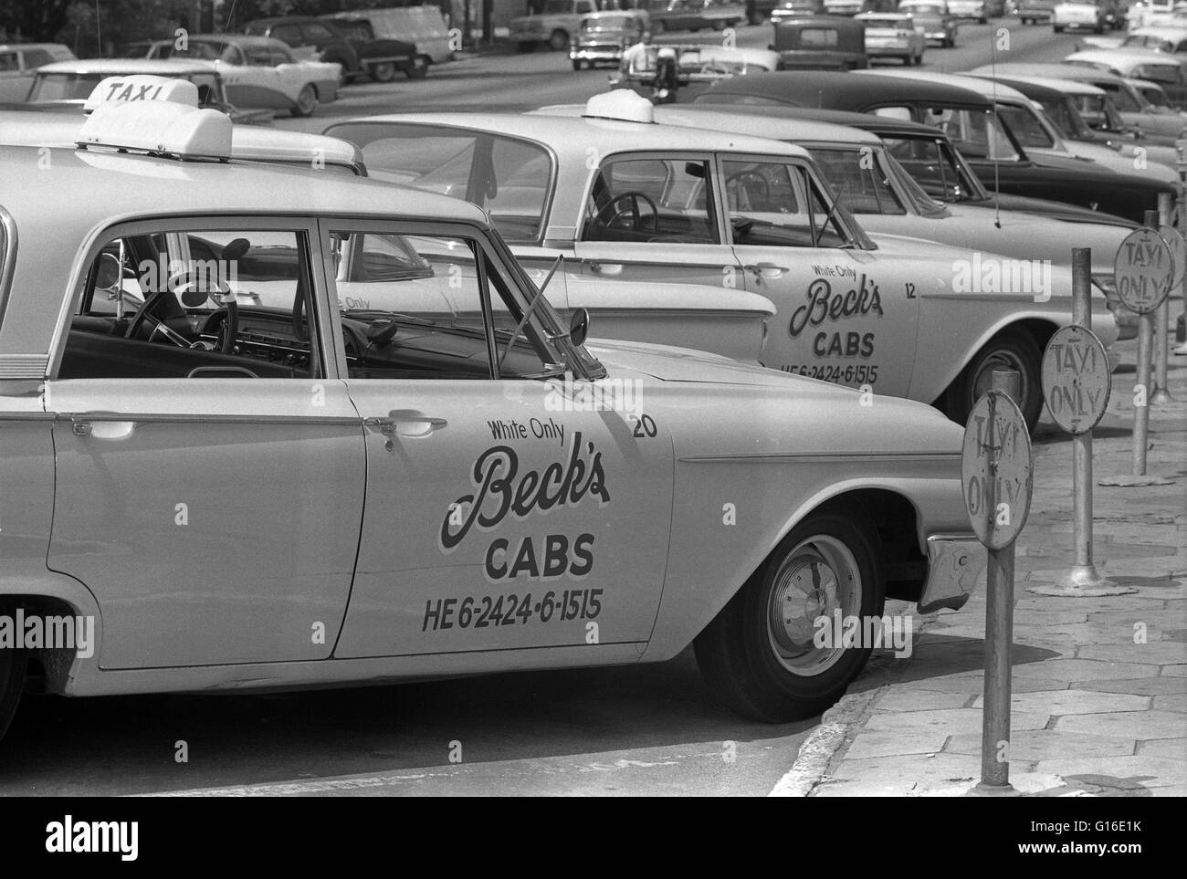 Entitled: 'Taxi cabs with sign 'White only, Becks cabs' on side, Albany, Georgia.' Segregation is separation of humans into racial groups in daily life. It may apply to activities such as eating in a restaurant, drinking from a water fountain, using a pub Stock Photo