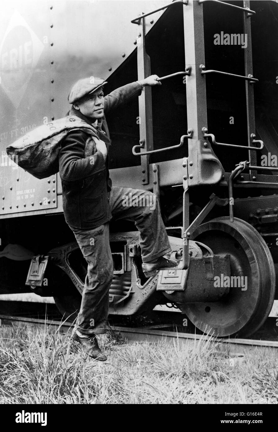 Entitled: 'Lou Ambers with a large bag over his shoulder, mounting the ladder of a train car.' A hobo is someone who wanders from place to place without a permanent home or a means of livelihood. With the end of the American Civil War in the 1860s, many d Stock Photo