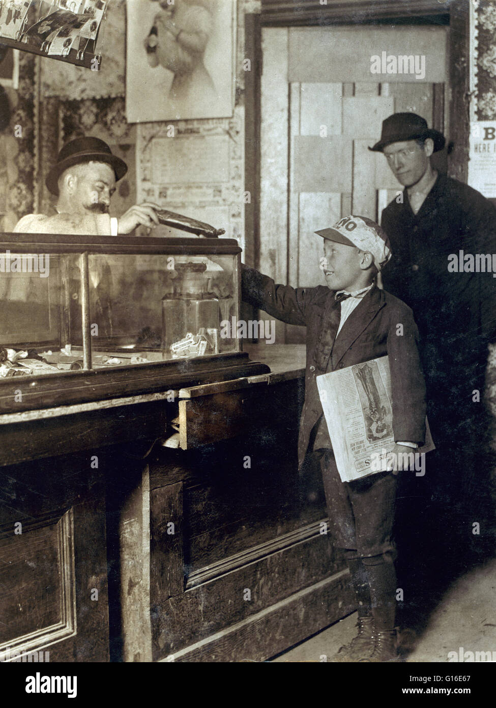 Entitled: 'Where the money goes to. Bach Branch Office usually has a candy counter. 4020 Manchester St. Location: St. Louis, Missouri. May 1912. The position of paperboy occupies a prominent place in many countries, including the United States, Canada, Un Stock Photo