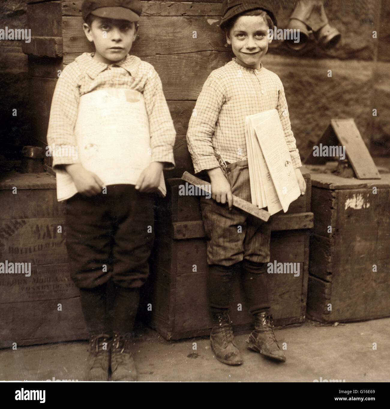 Entitled: 'Two of the very youngest newsboys I could find in New Orleans. Seven and nine years old. Such little fellows are rare. Location: New Orleans, Louisiana. November 1913.' The position of paperboy occupies a prominent place in many countries, incl Stock Photo
