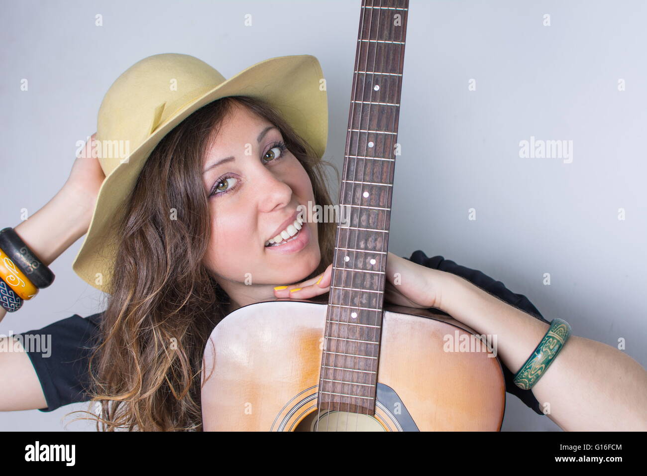 Attractive young woman with a guitar Stock Photo - Alamy