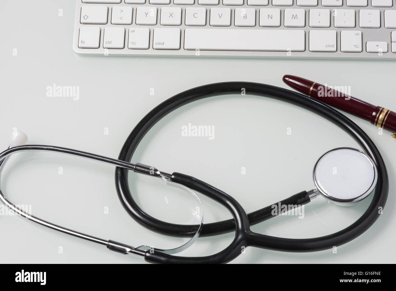 stethoscope, fountain pen and keyboard on doctor's desk Stock Photo - Alamy