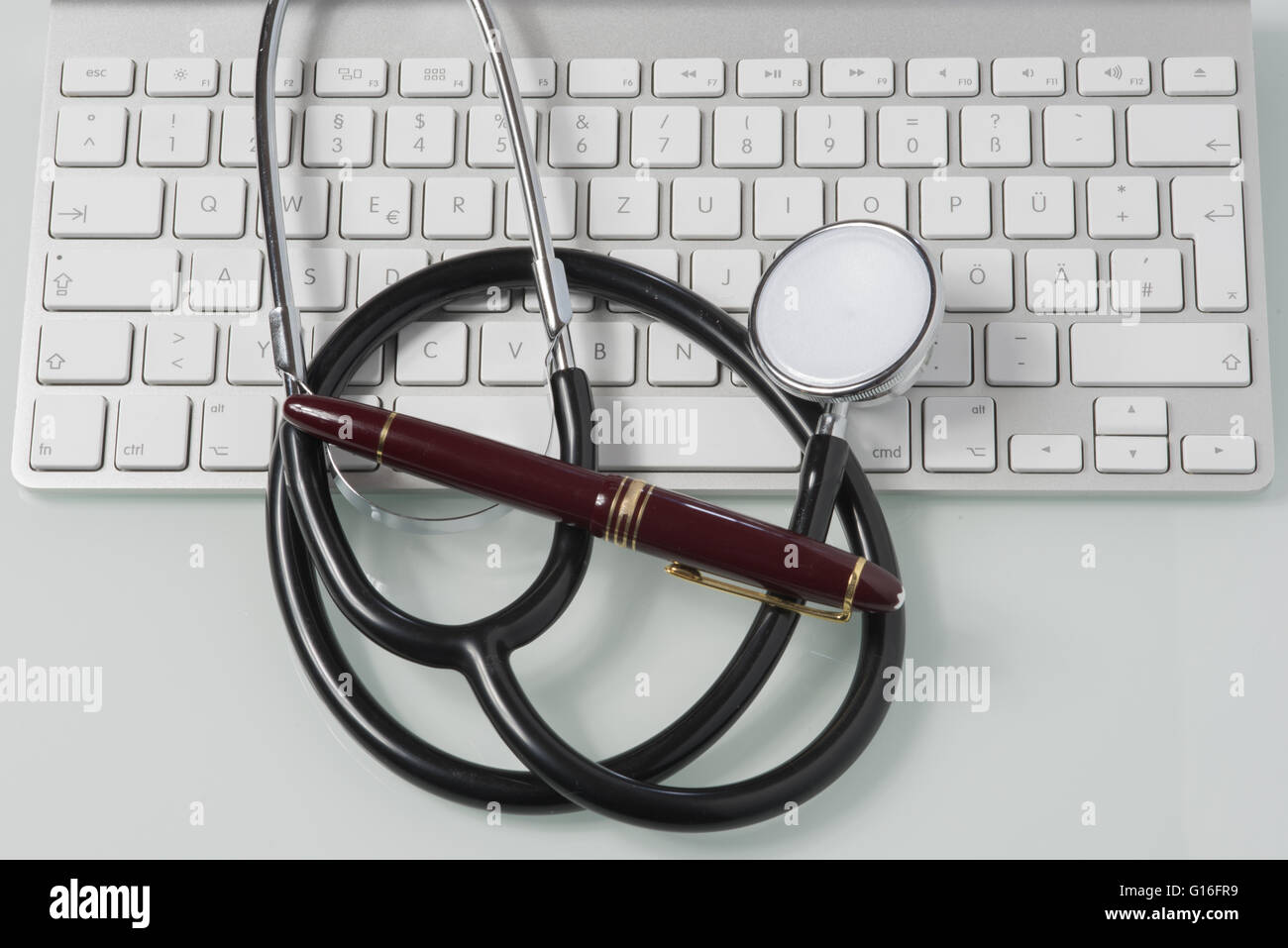 stethoscope, fountain pen and keyboard on doctor's desk Stock Photo - Alamy