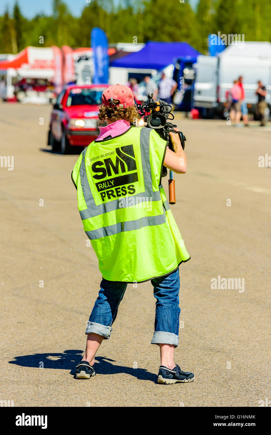 Emmaboda, Sweden - May 7, 2016: 41st South Swedish Rally in service depot. Female cameraman documenting life in the depot here s Stock Photo