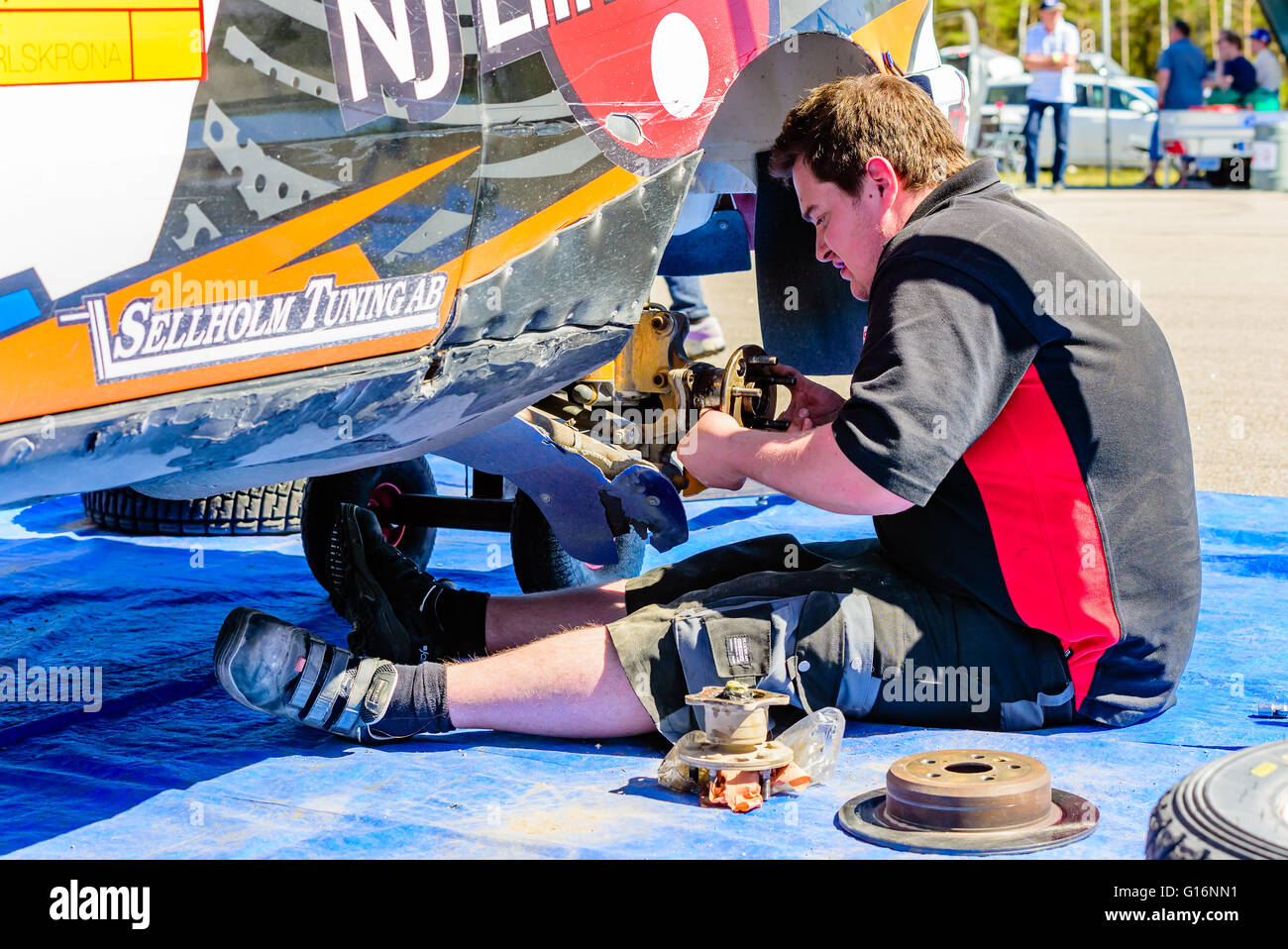 Emmaboda, Sweden - May 7, 2016: 41st South Swedish Rally in service depot. Mechanic working with changing wheel bearing on team Stock Photo