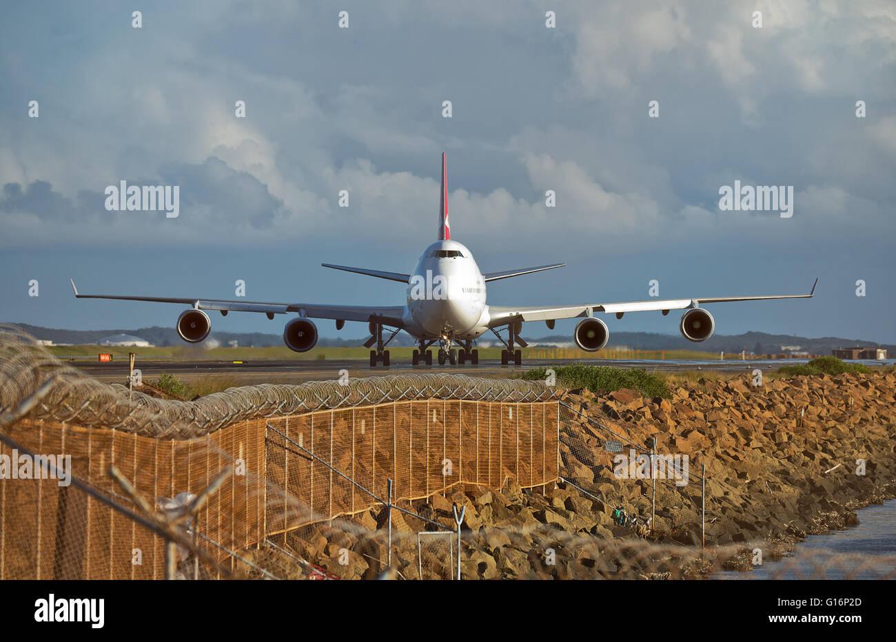 A QANTAS Boeing 747-400 taxis towards the terminal after landing at the city's airport. Stock Photo