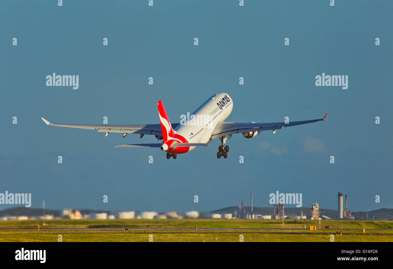 A QANTAS Airbus A330 takes off from Sydney and past Port Botany. Stock Photo