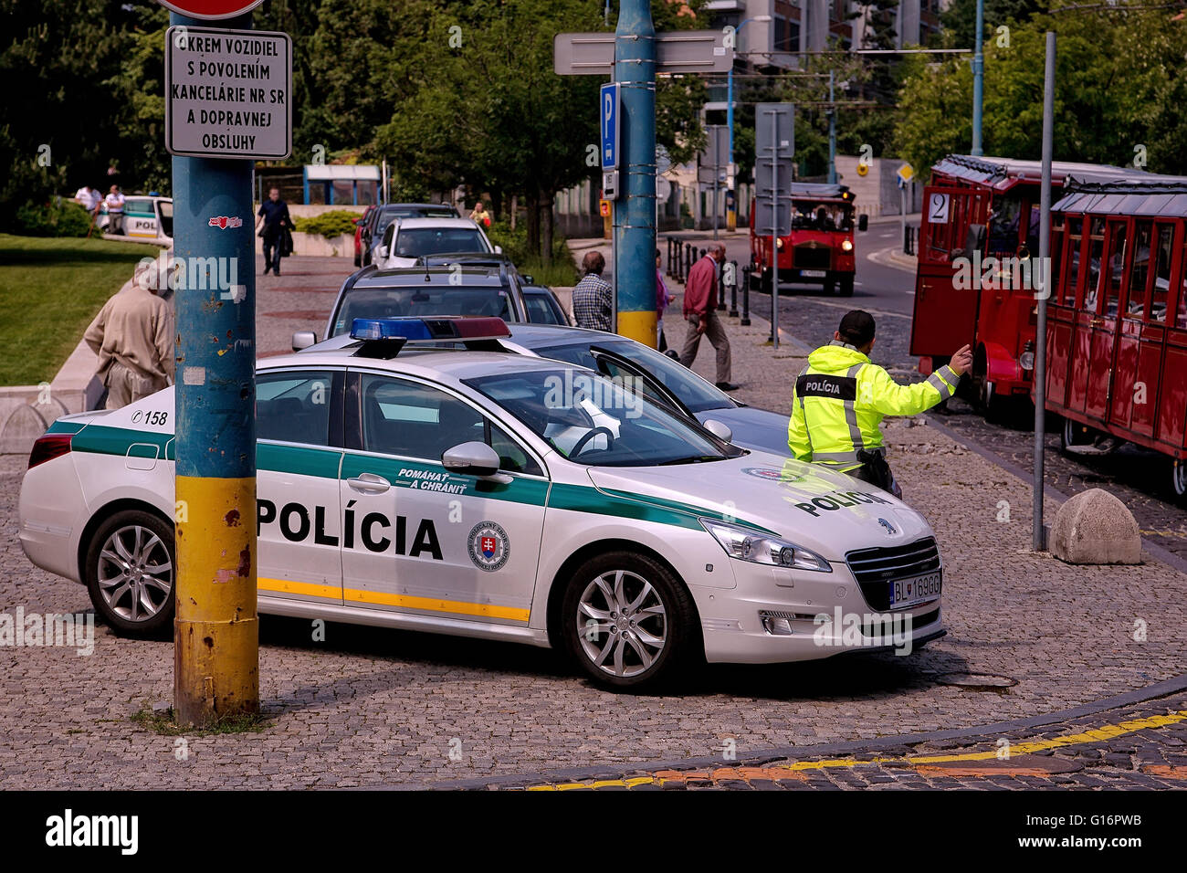 Police car with policeman on the street in Bratislava, Slovakia Stock Photo