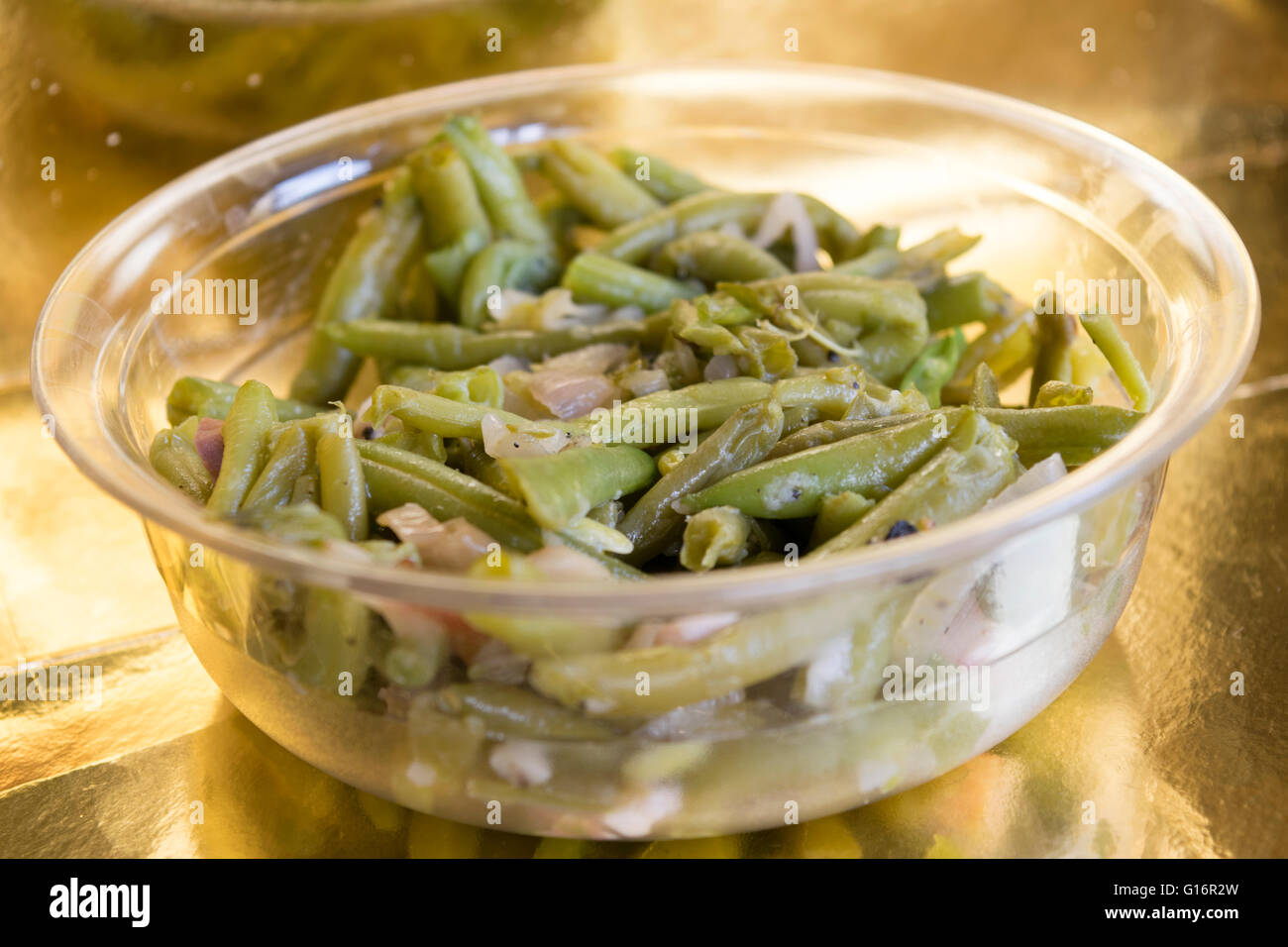 french beans stir-fried with bacon and served on a glass bowl Stock Photo