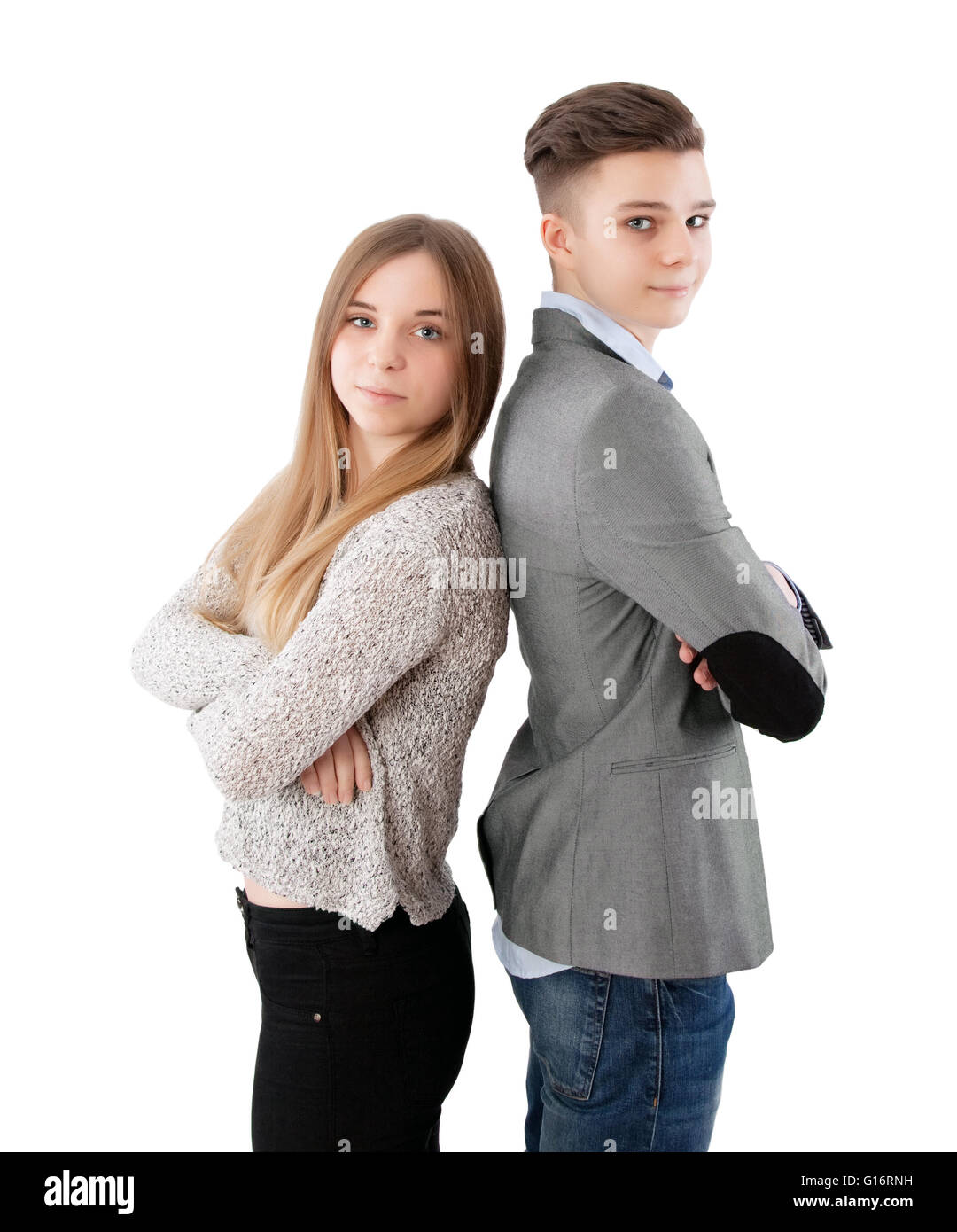 brother and sister standing back to back Stock Photo