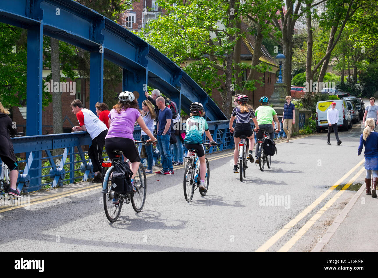 A family cycling across Kingsland Bridge, Shrewsbury, Shropshire, England, UK Stock Photo