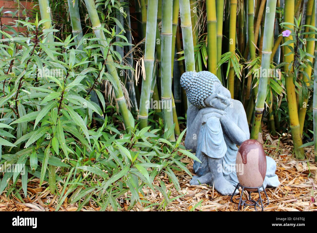 bamboo garden buddha statue shiva lingam stone Stock Photo