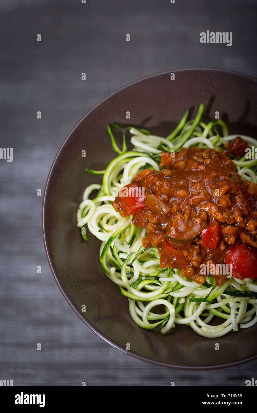 A bowl of courgette (Zucchini) spaghetti with a bolognese sauce Stock Photo